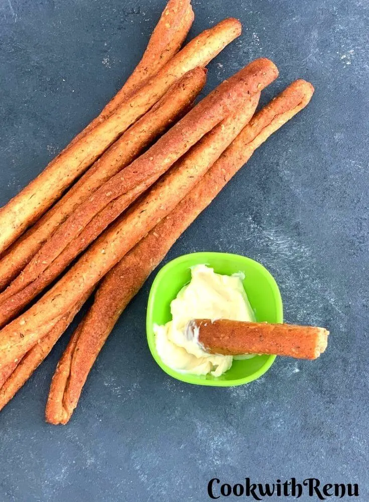 Crunchy Herbed Whole Wheat Breadsticks, served with some cheese