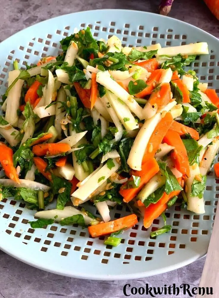 Close up look of Kohlrabi, Carrot, and Spinach Salad served on a plate