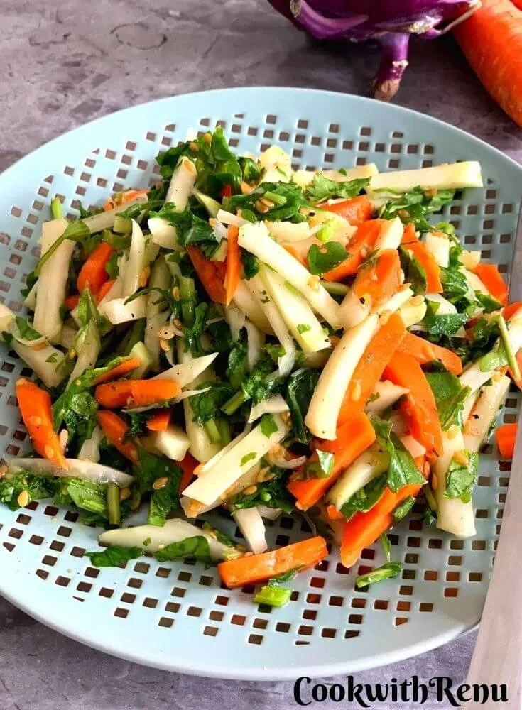 Kohlrabi, Carrot, and Spinach Salad served on a plate