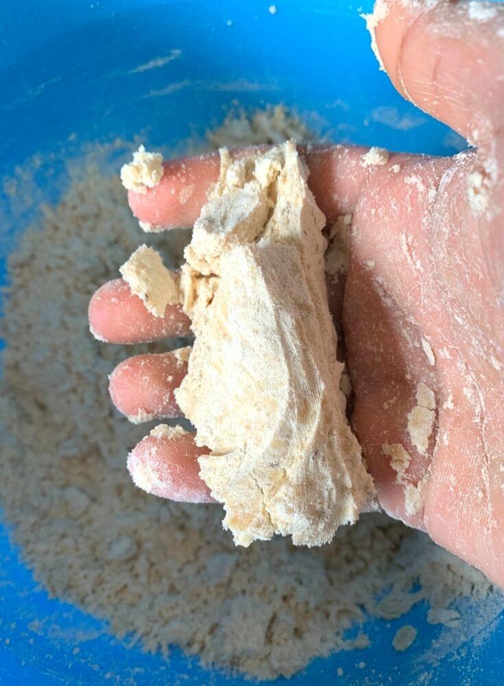 Testing the ghee inside dough by pressing in between your hands