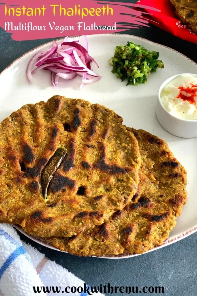 Instant Thalipeeth is a Multiflour Vegan Flatbread that is enjoyed as breakfast and is an instant version of th e typical Maharashtrian Bhajani che Thalieepth. Thalipeeth served in a white plate with yogurt, green chilly and onion along with some buttermilk
