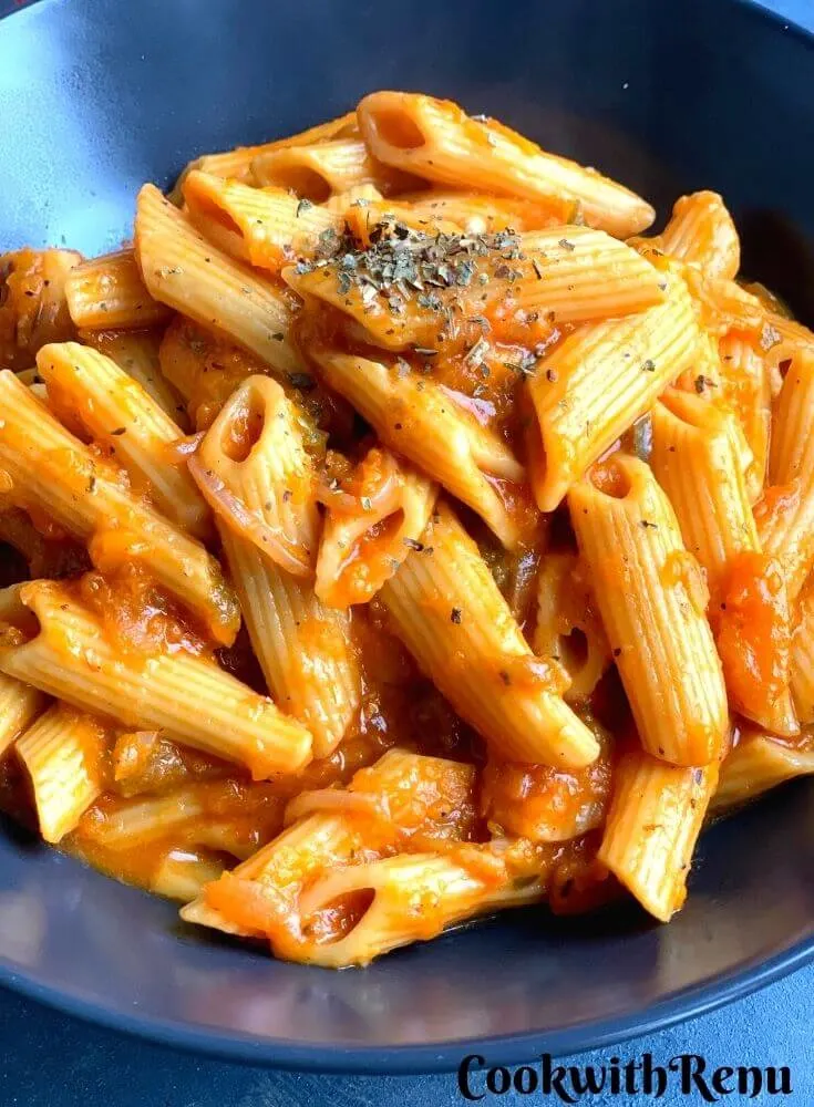 Close up look of pasta bowl served in a blue bowl.