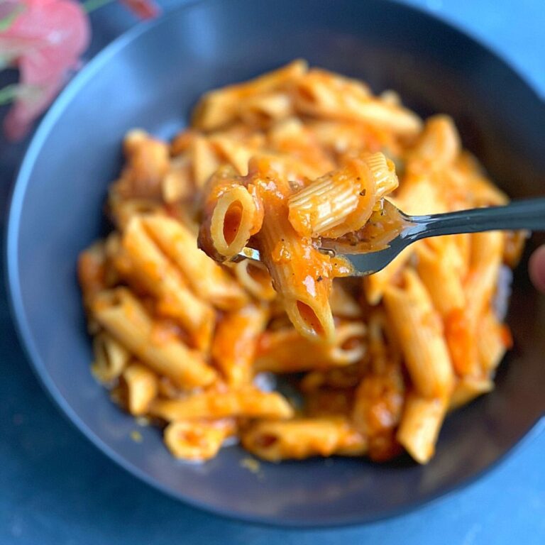 Vegan Butternut Squash Pasta is creamy and rich, one-pot cheese-free and dairy-free pasta made in an instant pot or open pot. Close up look of the pasta picked up on a fork.