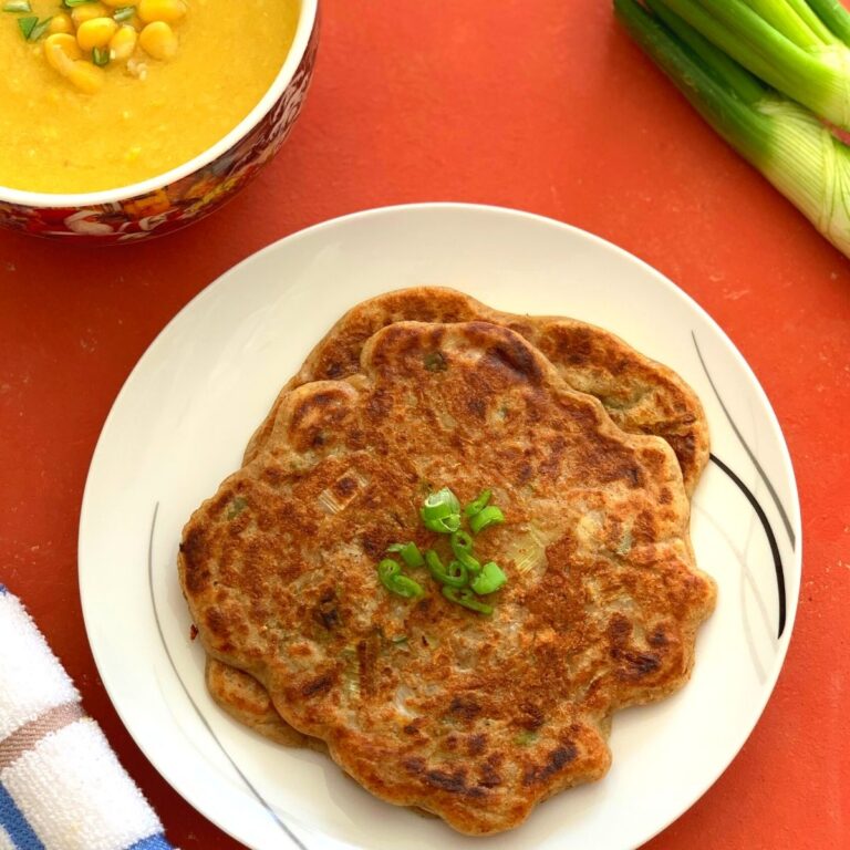 Sourdough Discard Scallion Pancakes served on a white plate, with Sweet Corn soup seen on the side along with some green scallion
