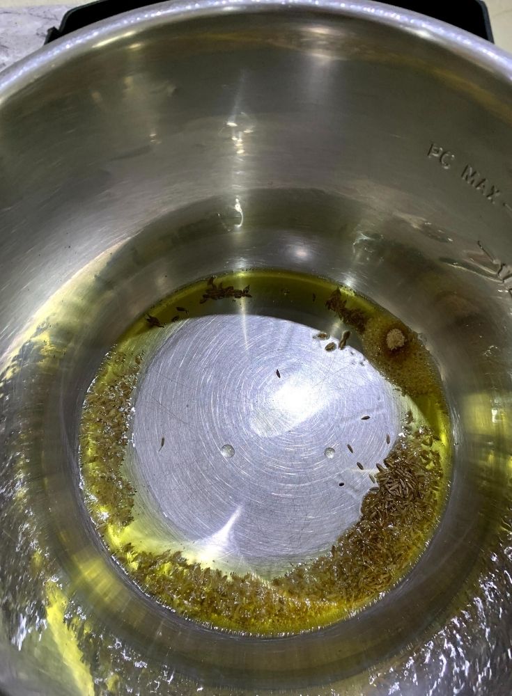 Adding of Cumin seeds and Asafotetida
