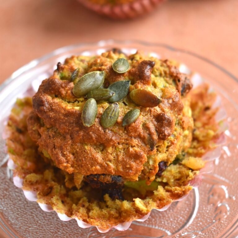 Close up look of breakfast muffins on a plate with nice texture and sunflower seeds topped on it