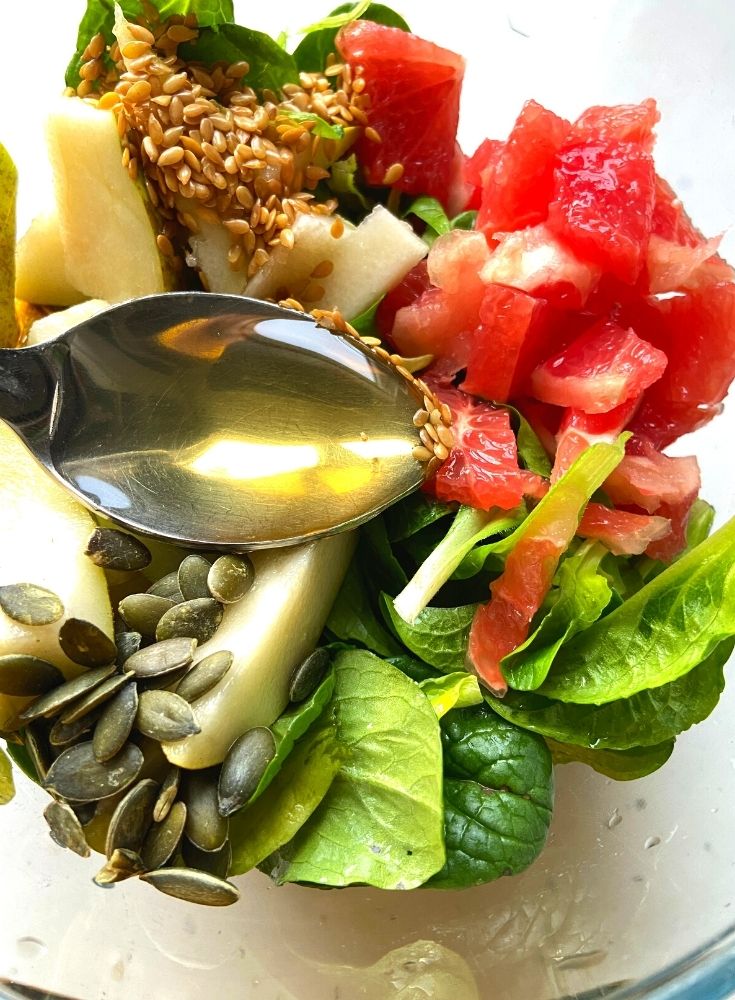 Adding of honey, seeds in salad