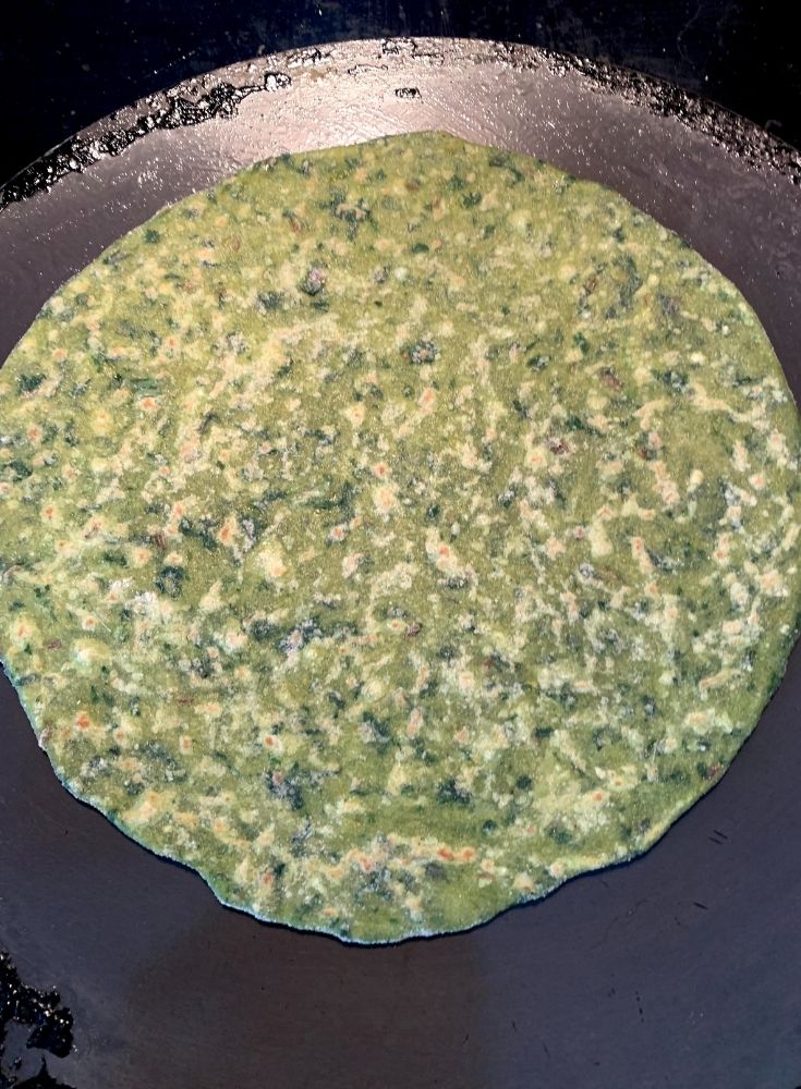 paratha being cooked for first 20-30 seconds on the bottom side, now getting cooked on the other side