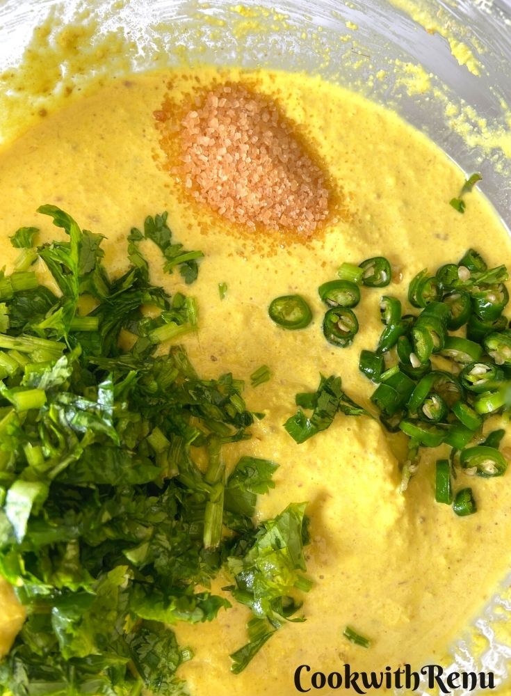 Adding of coriander, sugar and green chilly in the batter