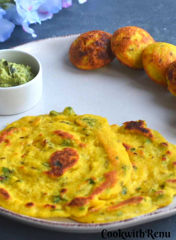 Dhuska pancake and appe served in a white dish with coconut chutney