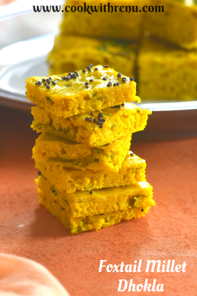 Foxtail millet dhokla stacked up and presented , seen in the background is some more dhokla served on a plate