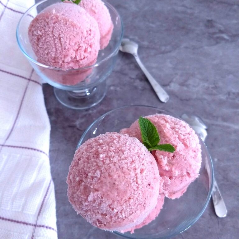 Sugar-Free No-Churn Strawberry Banana Ice Cream served in 2 bowls with some fresh mint seen as garnish