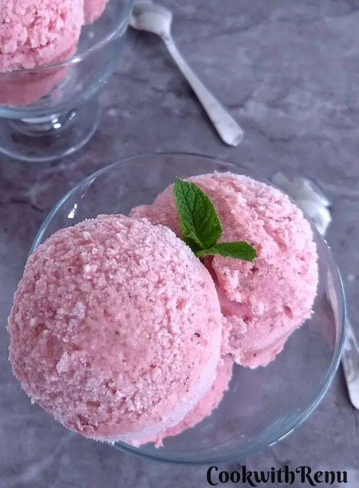 Sugar-Free No-Churn Strawberry Banana Ice Cream served in 2 bowls with some fresh mint seen as garnish