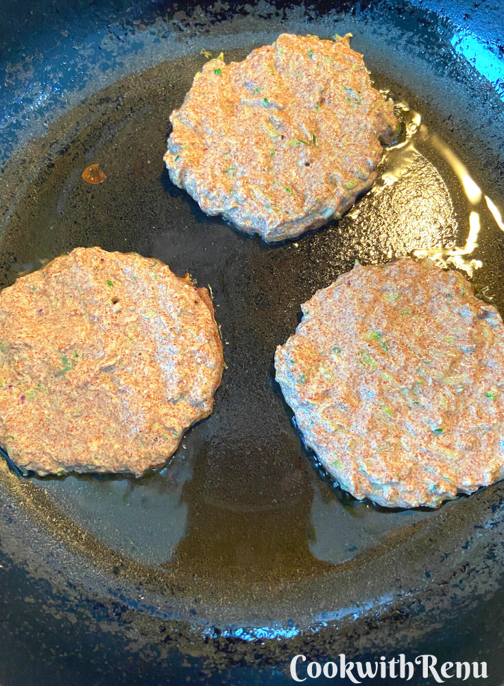 Fritters cooking on one side