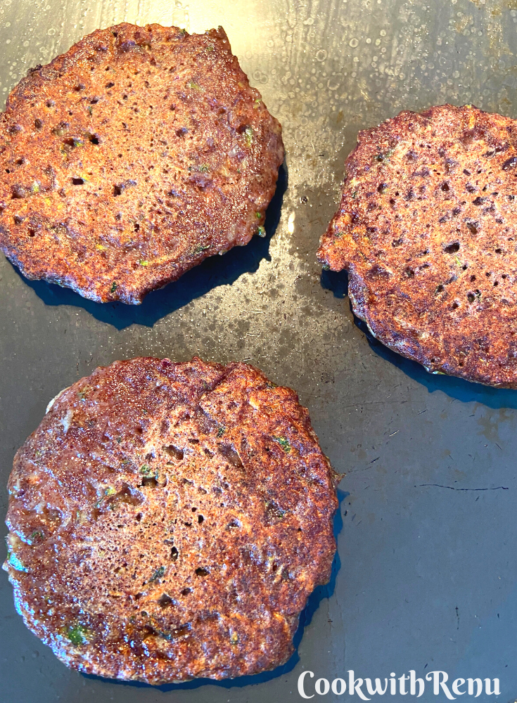 Fritters cooking on other side