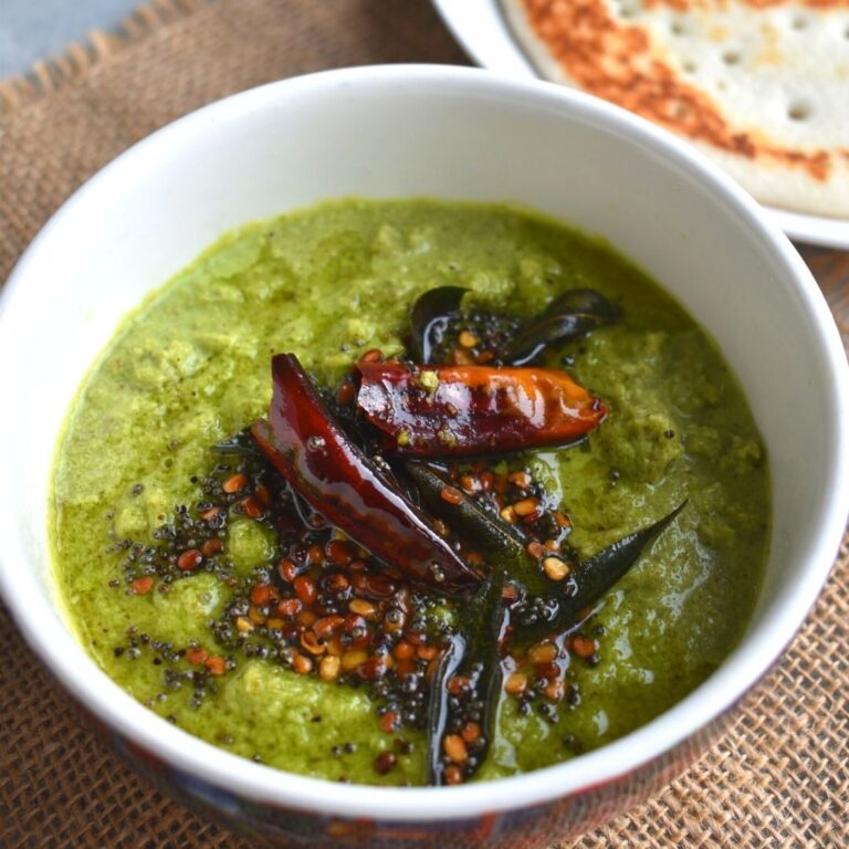 Close up look of Coconut Coriander chutney served in a white bowl, served along with Malvani Amboli