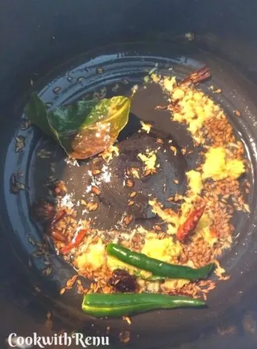 Adding of ginger and green chilli in the tadka