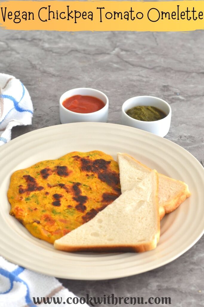 Vegan Chickpea Tomato Omeletee served with a bread slice along with tomato ketchup and green coriander chutney