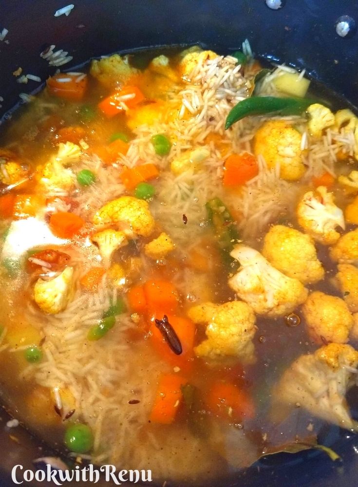 Water added to the rice and vegetable mixture