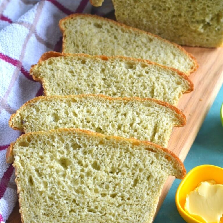 Bread slices arranged on a board with some butter on the side