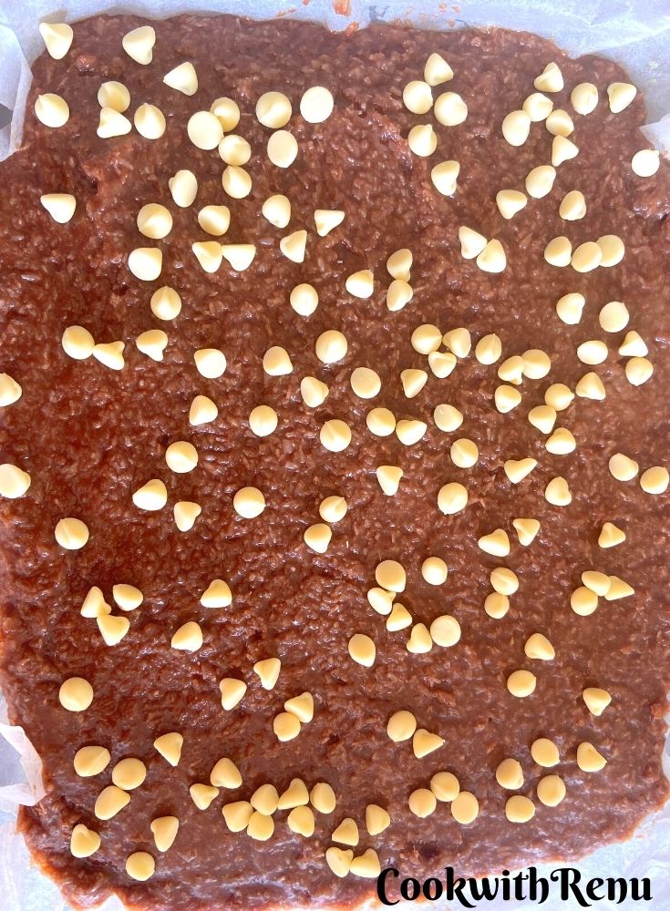 Chocolate Coconut Ice set in a tray with chocolate chips on top