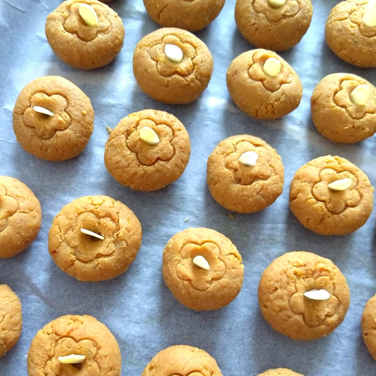 Soft and chewy Microwave Caramel Coconut peda arranged on a tray.