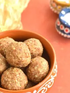 Oats Energy Bites in a brown bowl. seen in background are some diyas