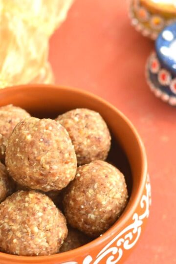 Oats Energy Bites in a brown bowl. seen in background are some diyas