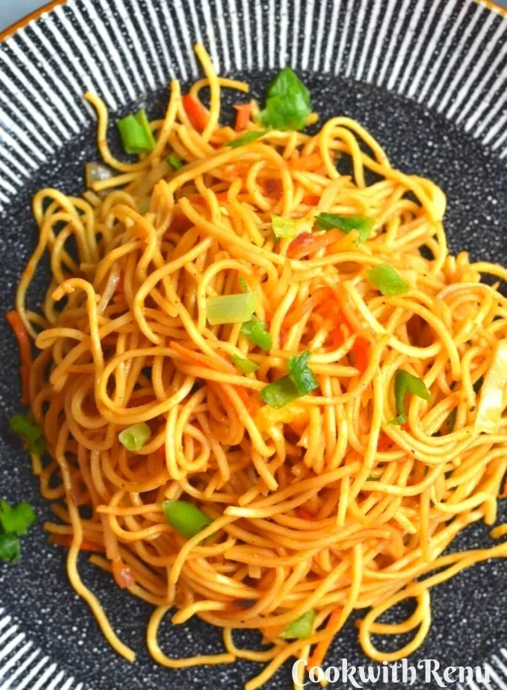 Close up look of noodles served on a black plate