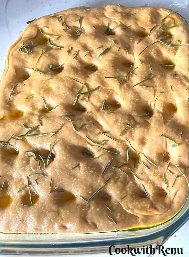 Oil and herbs drizzled on focaccia bread