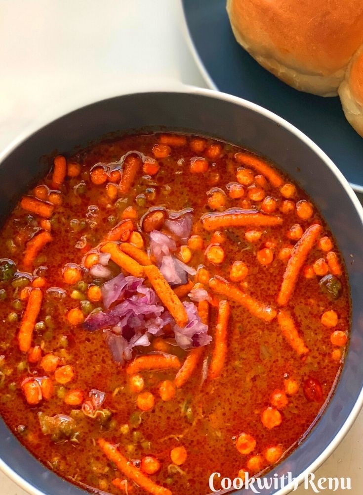 Close up look of Misal Curry topped with onion and farsan