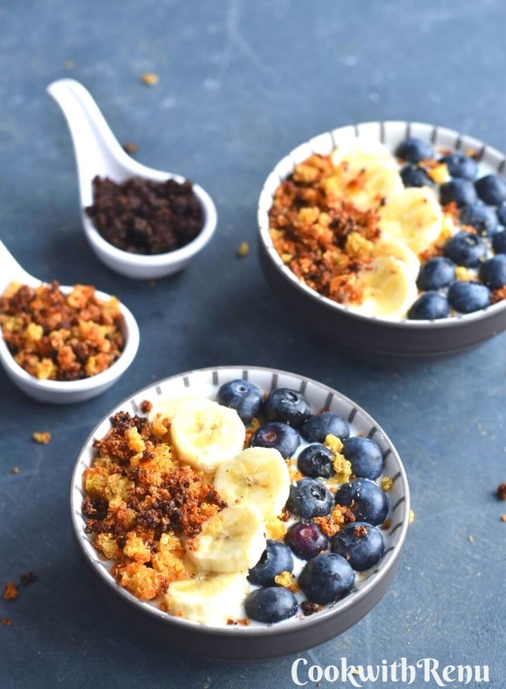 Quinoa crispies served in yogurt bowl along with banana and blueberries