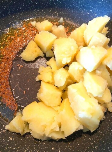 Adding potatoes in the mixture