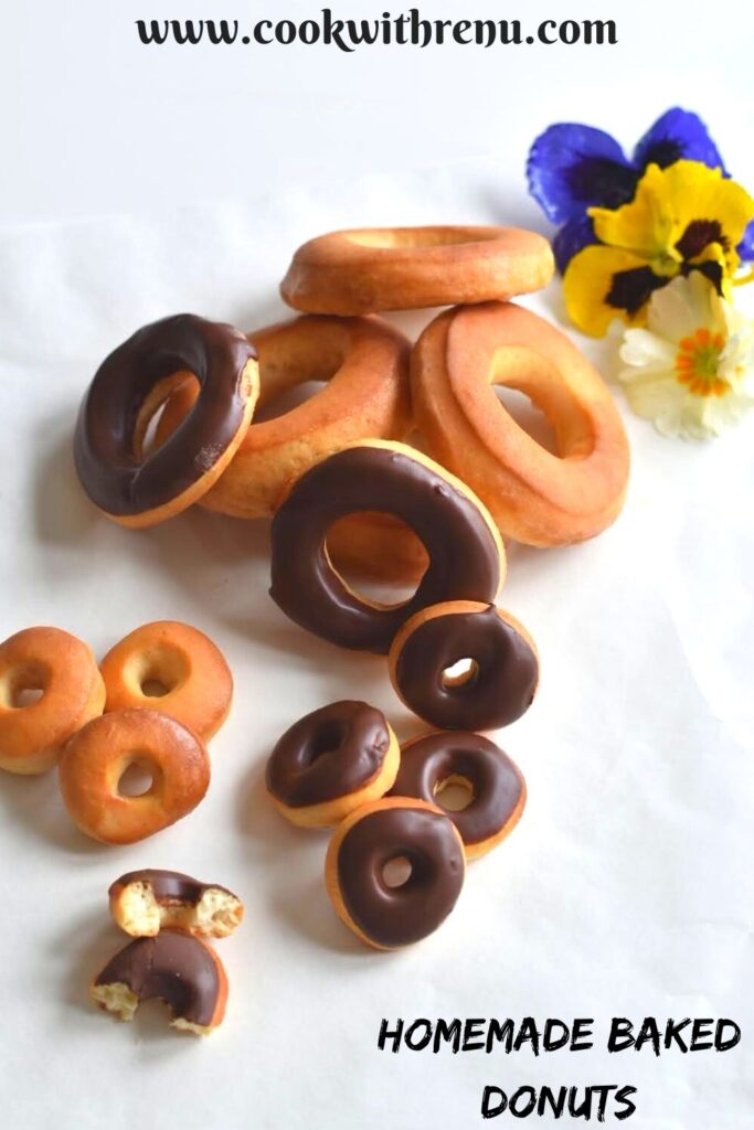 Sugar and Chocolate glazed mini and big size donuts with some edible flowers on the side