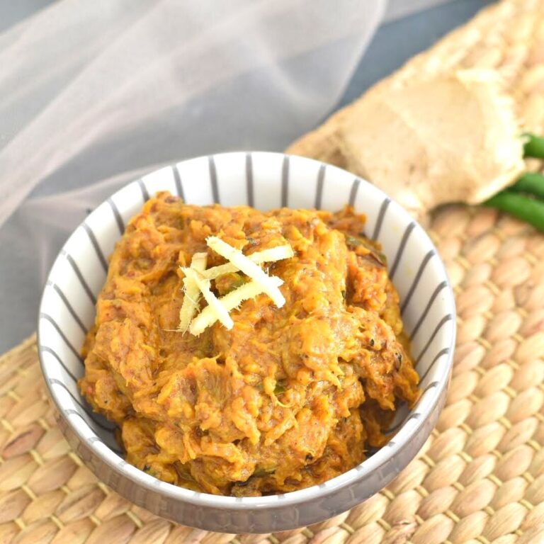 Smoked eggplant mash served in a bowl with a garnish of ginger