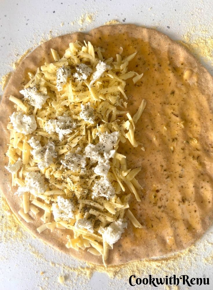 Adding of cheese and herbs in half of the mixture