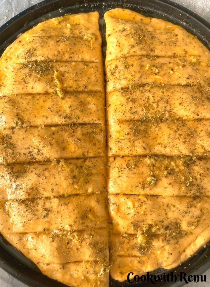 Applying of butter, garlic and herbs on the top