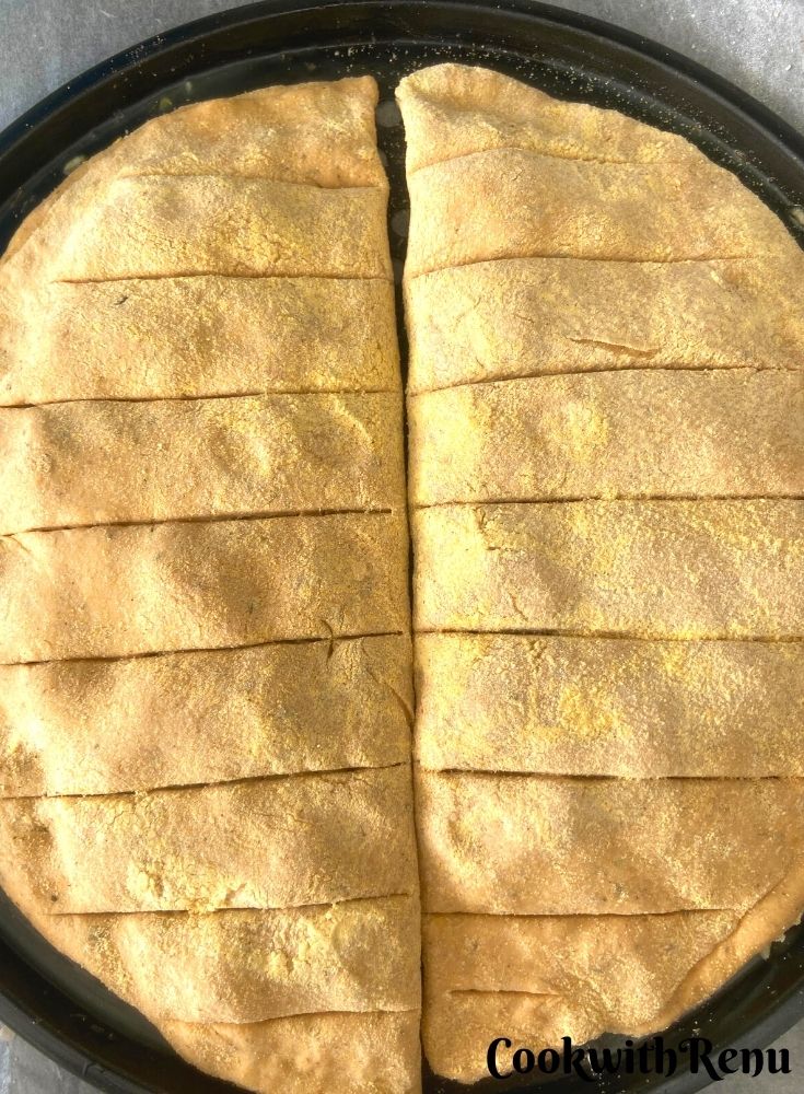 Cuts made on garlic bread sticks to be baked