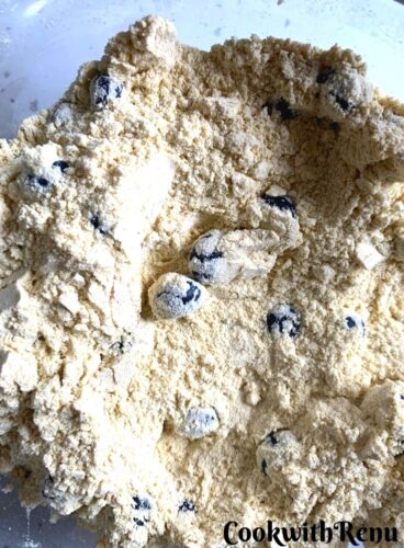 Mixing of Blueberry and Lemon Zest in flour