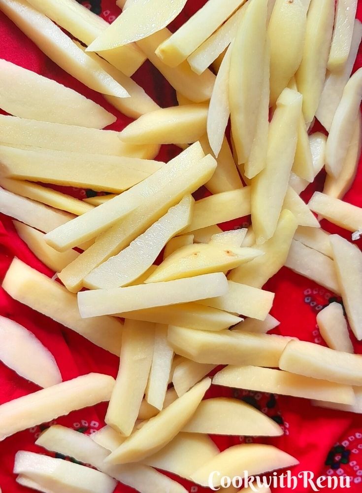 Potatoes being pat dry on a towel