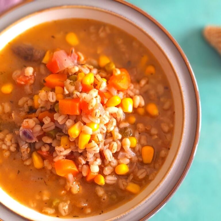 Vegetable Barley Soup served in a white bowl with grey lining.