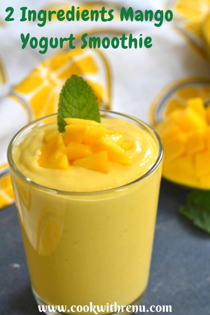 Close up view of Mango Yogurt Smoothie served in a glass, with a garnish of chopped mango and mint