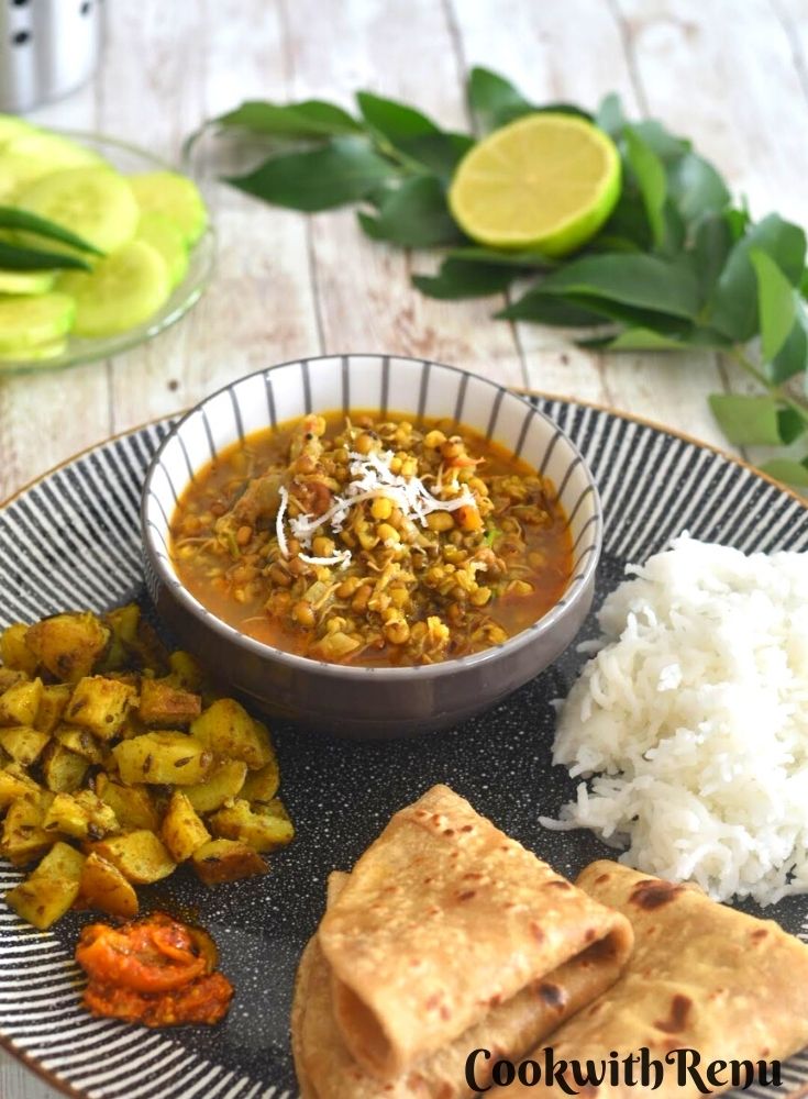 A Simple everyday thali from Maharashtrian Cuisine, with white steamed rice, 2 roti, potato bhaji, achaar, sprouted moong beans curry and cucumber