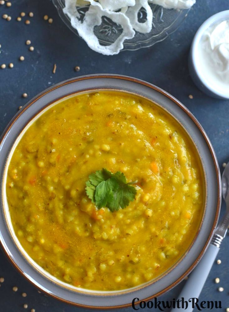 Jowar Millet and dal Khichdi served in a grey bowl served in a grey bowl, with curd and some papad