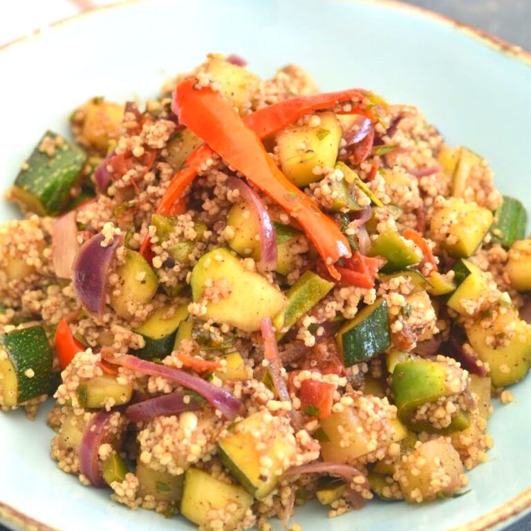 Couscous with Spiced Zucchini served in a wide blue bowl