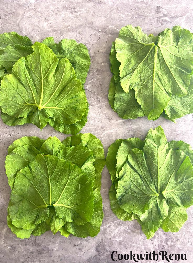 The leaves are divided into 4 batches and arranged on a table.