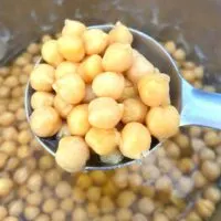 Chickpeas seen in a ladle, on an Instant Pot.