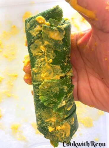 Patra Vadi Roll Prepared and a close up pic of it is seen in hand.