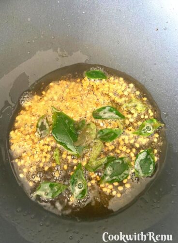Tempering of mustard seeds, black gram dal and curry leaves