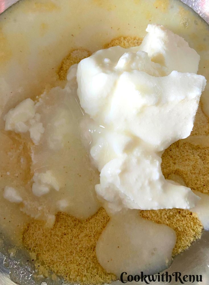 Adding yogurt whey and water to semolina.